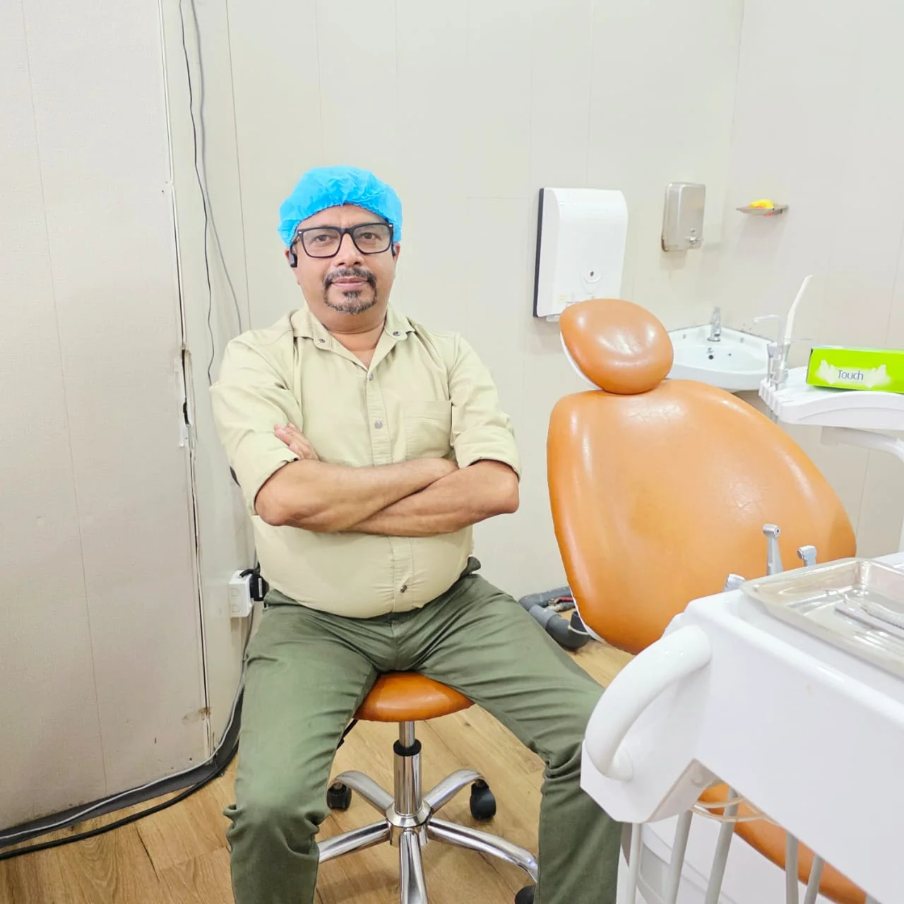 Doctor seated beside the dental chair